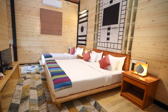 Deluxe twin guest room at The Feel Luxury Boutique Hotel Ella with wood paneling and colorful bed runners