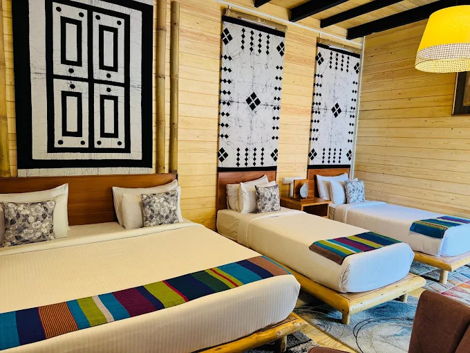 Family triple room at The Feel Luxury Boutique Hotel Ella with wooden walls and batik wall art