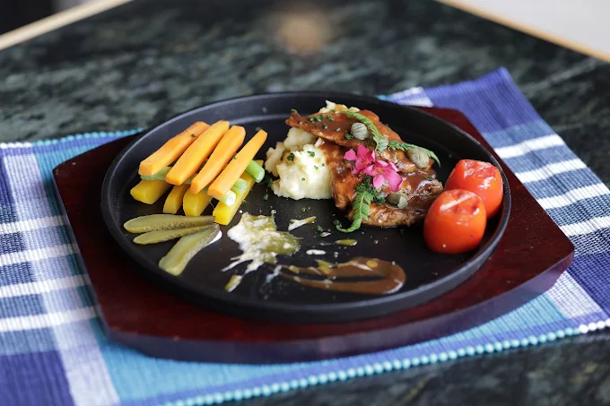 Gourmet grilled main course with mashed potatoes at The Feel Hotel Ella restaurant
