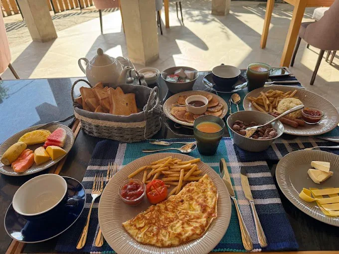 Outdoor breakfast spread with tropical fruit omelet and pancakes at The Feel Hotel Ella